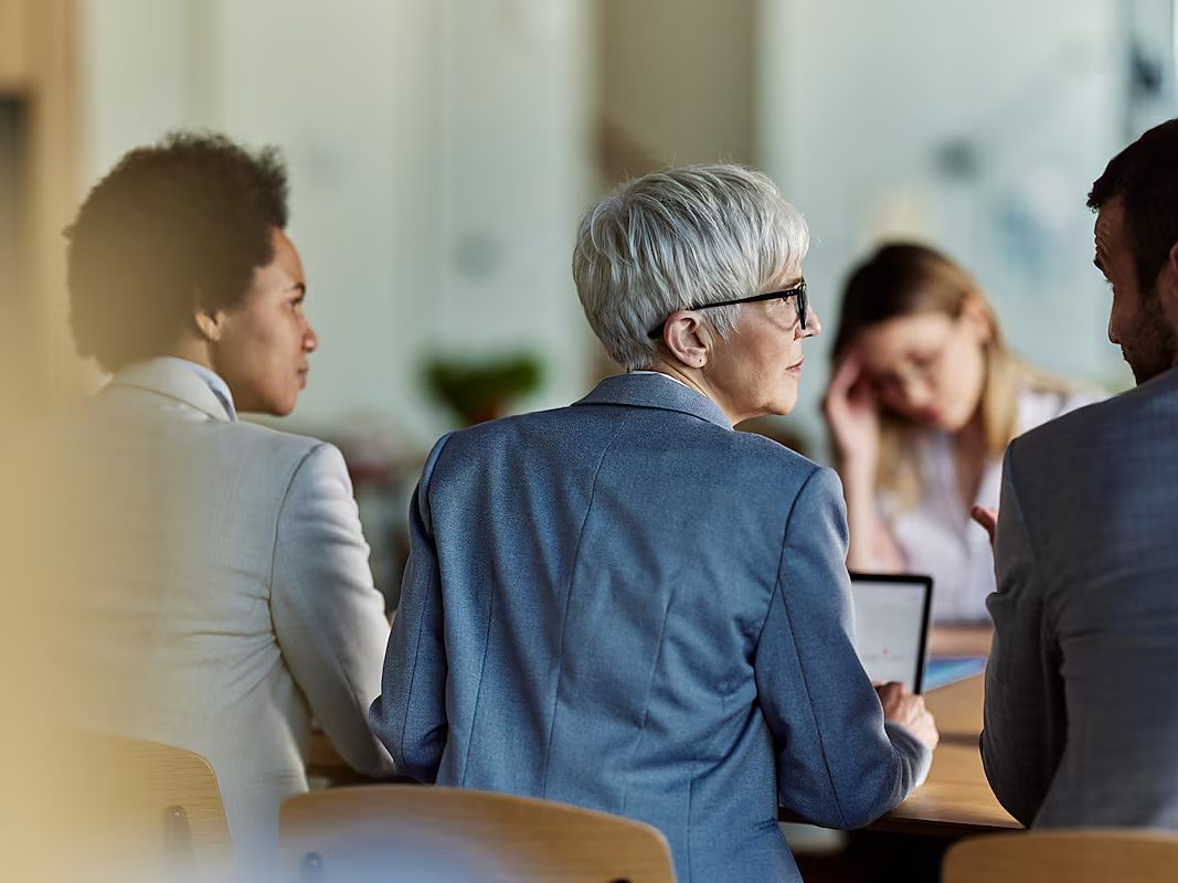 An advisor meets with a couple at a table